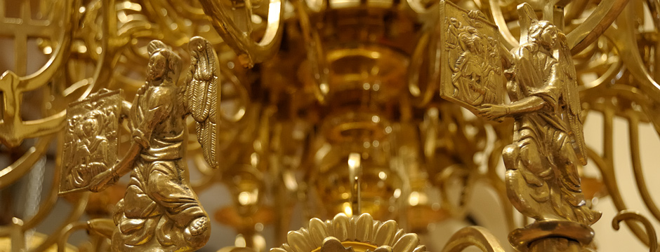 Interior of the Greek Orthodox church. In traditional Greek Orthodox churches, a beautiful circular chandelier with depictions of the saints and apostles, called the horos, hangs beneath the dome.